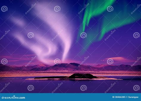 Northern Lights Aurora Borealis In The Night Sky Over Beautiful Lake
