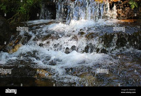 Splashes And Drops Of Water In A Small Waterfall On A Mountain Stream