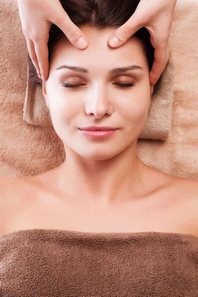 Eautiful Young Relaxed Woman Enjoy Receiving Face Massage At Spa Saloon