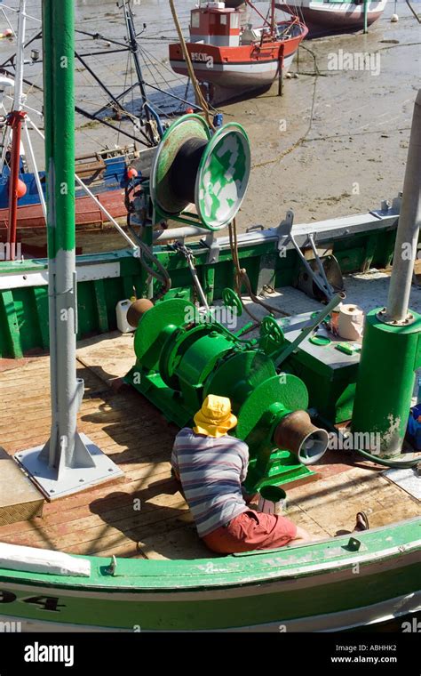 Fisherman Painting Trawler Fishing Boats Winch With Green Paint At Low