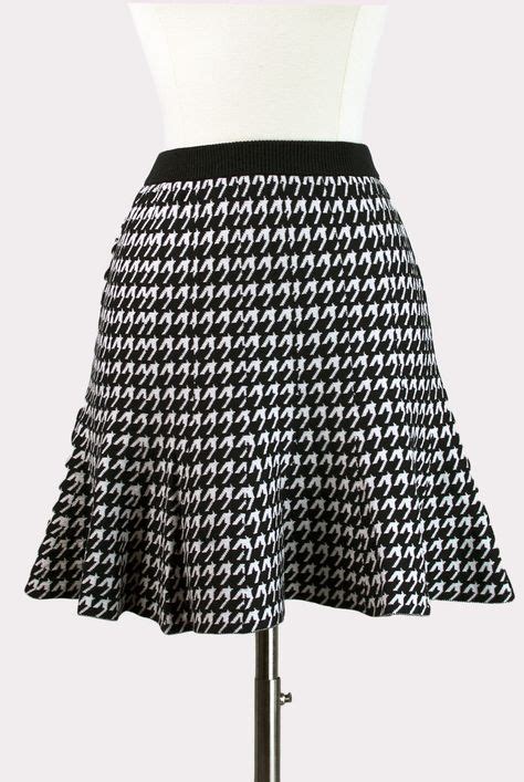 this item is final sale black and white houndstooth mini skirt with flared silhouette and solid