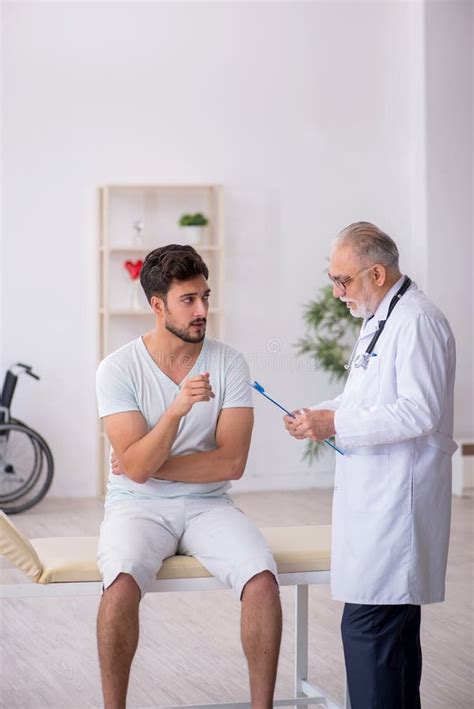 Young Male Patient Visiting Old Male Doctor Stock Photo Image Of