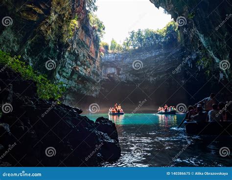 Tour By Boat Tourists In A Cave With An Underground Lake Melissani On