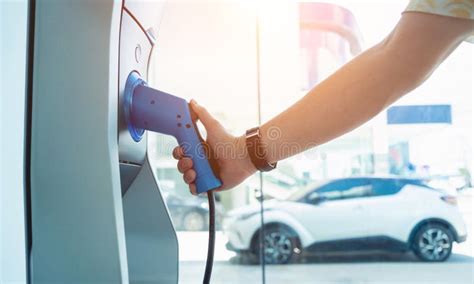 Man Charge His Electric Car At City Charging Station Stock Image