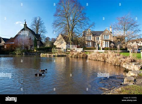 Houses Around A Typical English Village Duck Pond On The Green In Stock