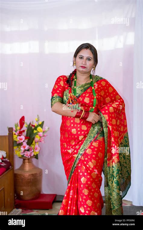 beautiful nepali women in a traditional dress up with wearing saree and jewelleries at teej