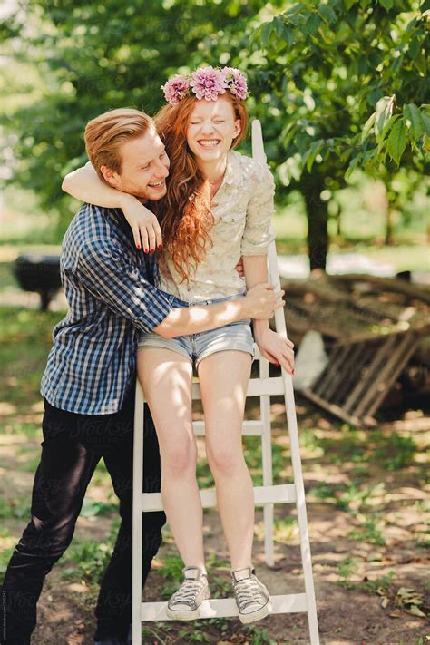 Smiling Ginger Couple In An Orchard By Lumina