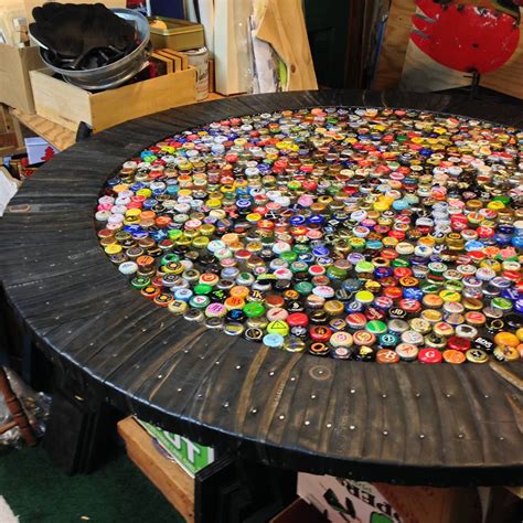 Then i realized the uneven surface would make the inevitable beer spill difficult to clean up. The Bottle Cap Table — Art by Loran Scruggs