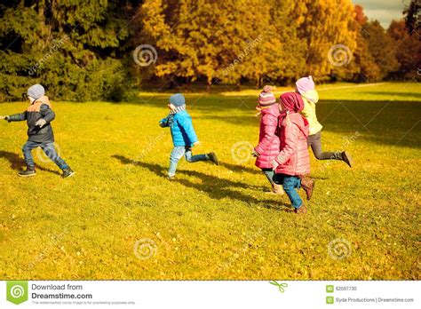 Group Of Happy Little Kids Running Outdoors Stock Photo Image Of