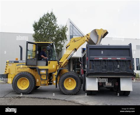 Dump Truck And Front End Loader Removing Asphalt In Turners Falls Stock