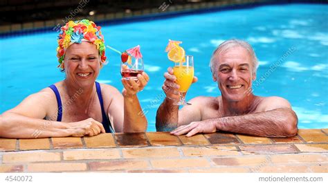 Happy Old Couple Relaxing In The Swimming Pool Stock Video Footage