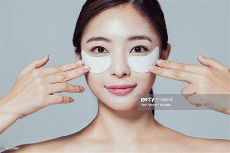 Woman Putting Eye Patch High Res Stock Photo Getty Images