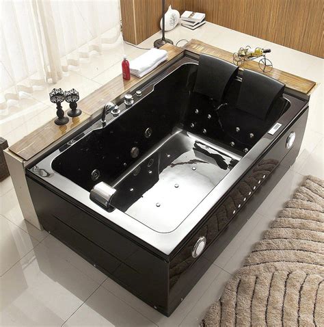 A Black And Silver Bath Tub Sitting On Top Of A White Tiled Floor Next