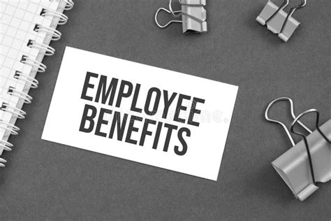 The Word Employee Benefits Word Written On Gray Background With Paper