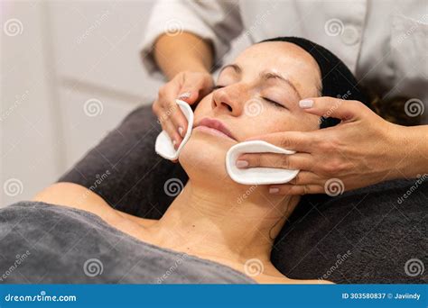 Relaxed Woman Having Facial Beauty Treatment In Spa Center Stock Image