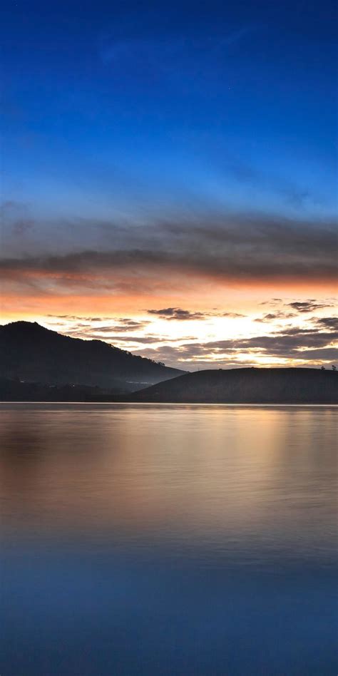 1080x2160 Mountains Silhouette Lake Sunset Wallpaper Sunset