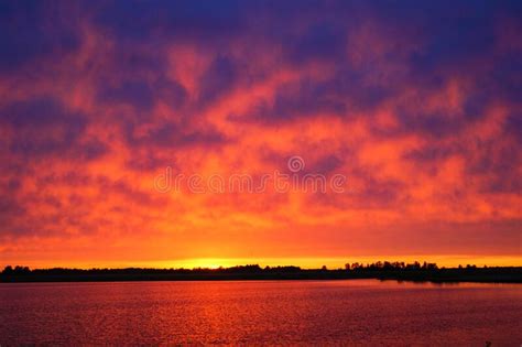 Beautiful Red And Pink Sunset Over The Lake In Summer Stock Photo
