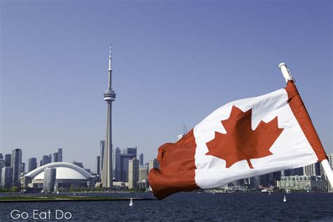 A Canadian Maple Leaf Flag Flutters On A Sunny Day In Toronto Ontario