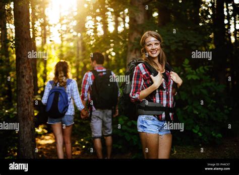 Beautiful Woman And Friends Hiking In Forest Stock Photo Alamy