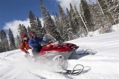 Two People Riding A Snowmobile Bakers Narrow