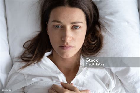 Depressed Young Woman Rest In Bed Suffering From Depression Stock Photo