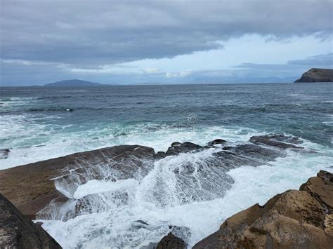 Stunning Seascape With Foamy Waves Hitting The Rocks Of The Seashore