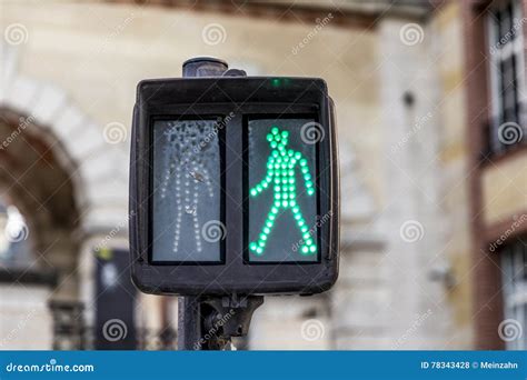 Green Man At Traffic Light Shows Right To Walk Stock Photo