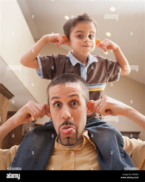 Father And Son 6 7 Pulling Funny Faces Stock Photo Alamy