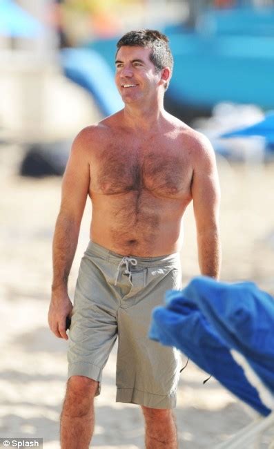 Simon Cowell S Got The Xmas Factor As He Shows Off His Buff Body On The Beach Daily Mail Online