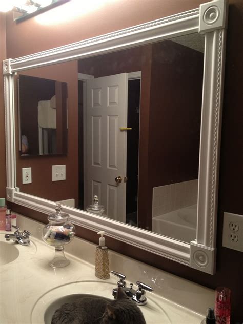Use construction adhesive to hold boards. DIY bathroom mirror frame. White styrofoam molding, wood ...
