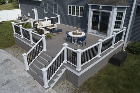 Transform Your Outdoor Space With A Stunning Tan Deck And Black Railing