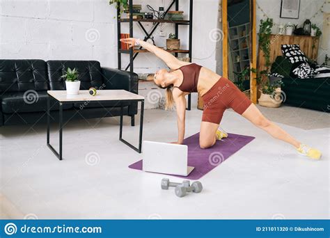 Flexible Fit Woman With Athletic Body Watching Online Stream On Laptop