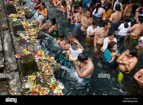 People Waiting In Line To Make Ritual Purification In The Holy Spring Tirta Empul Temple