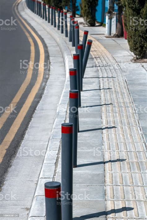 Row Of Street Bollards Between Road And Sidewalk Stock Photo Download