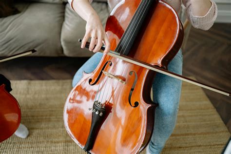 Person Playing Brown Violin On Brown Textile · Free Stock Photo