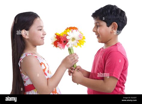 Boy Giving Flowers To A Girl Stock Photo Alamy