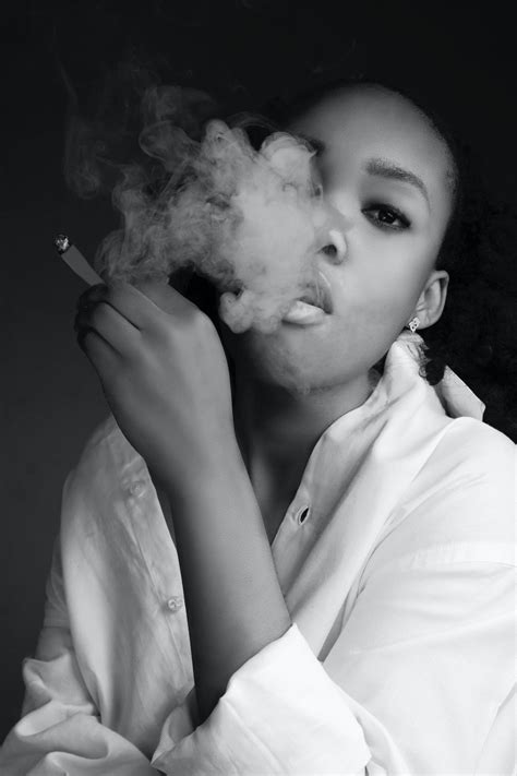 Black Woman Smoking Cigarette And Exhaling Smoke · Free Stock Photo