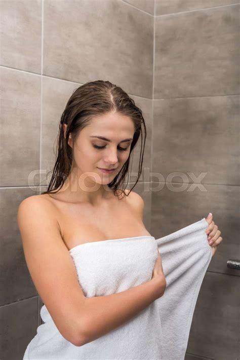 girl wrapping towel around body stock image colourbox