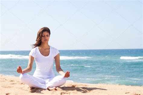 Young Beautiful Woman Meditation On Beach Stock Photo By ©michaeljung