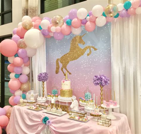 A Unicorn Themed Birthday Party With Balloons And Cake