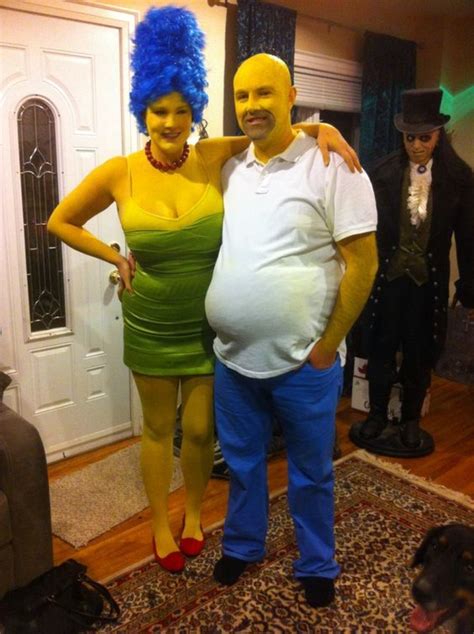 a man and woman dressed in costumes standing next to each other