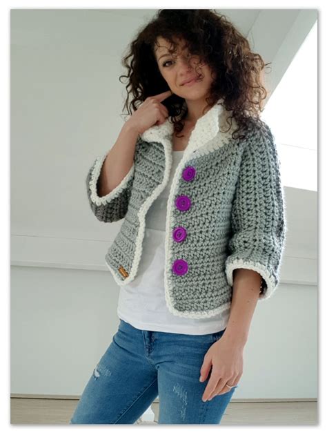 A Woman Is Posing For The Camera Wearing A Crocheted Jacket With