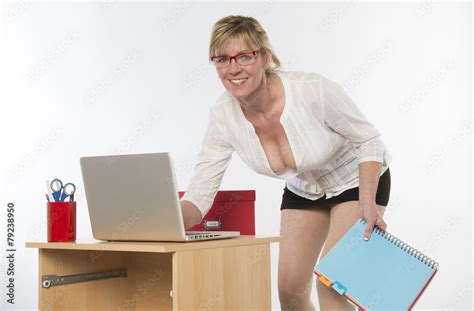 Sexy Secretary With Plunging Neckline Working At Desk Stock Photo Adobe Stock