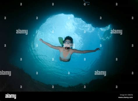Young Woman With Mask And Fins Dives In Underwater Cave Black Sea
