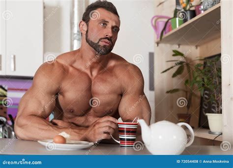Muscle Shirtless Bachelor Man Have A Breakfast In Kitchen Stock Photo