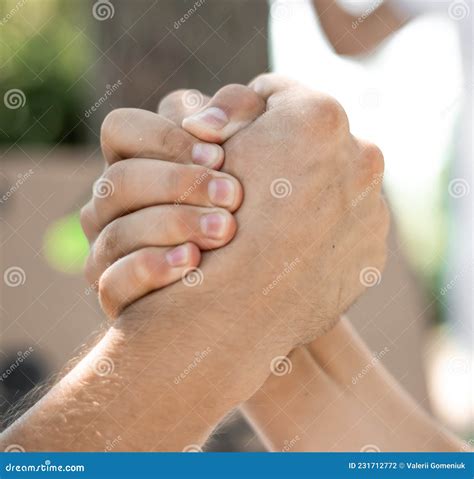 Two Hands Joined Together As A Greeting Or As In Armwrestling Stock