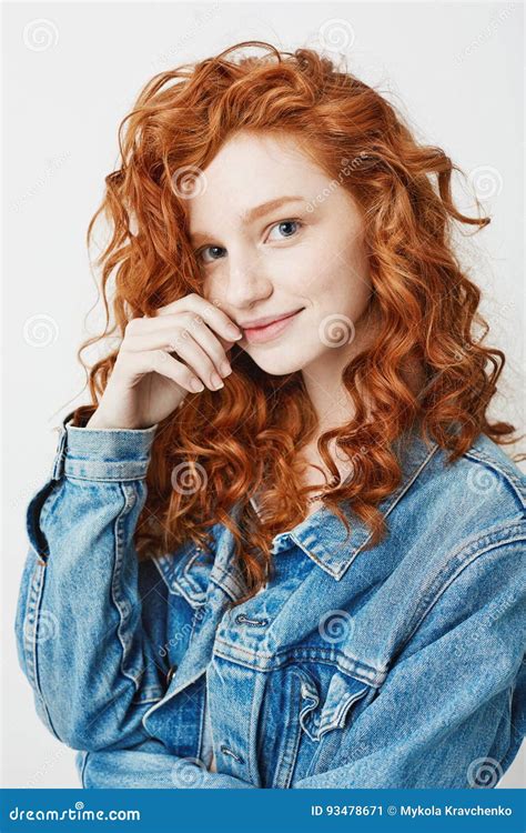 Portrait Of Cute Young Girl With Red Curly Hair And Freckles Smiling