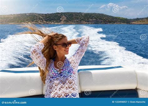 Woman With Sunglasses Enjoys A Boat Ride On A Sunny Summer Day Stock