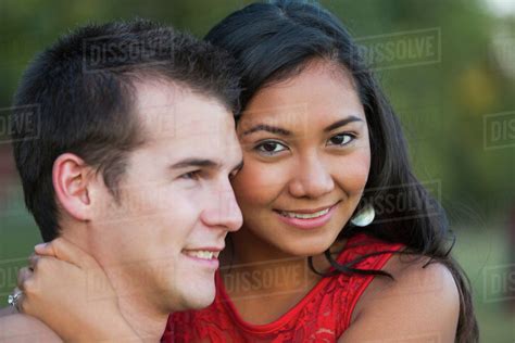 Mixed Race Couple Spending Quality Time Together In A Park In Autumn