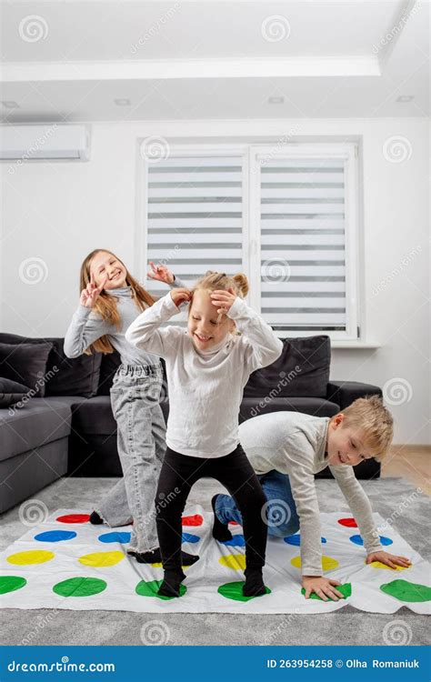 Group Of Children Playing Twister Game And Having Fun Concept Of